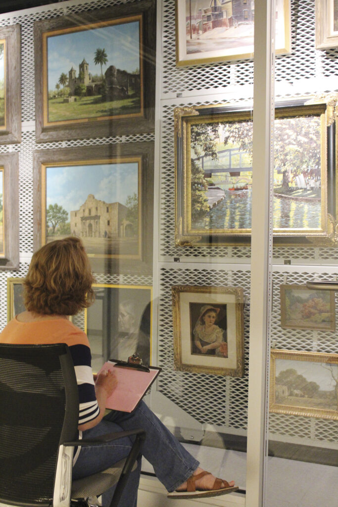 Woman sitting in front of frames