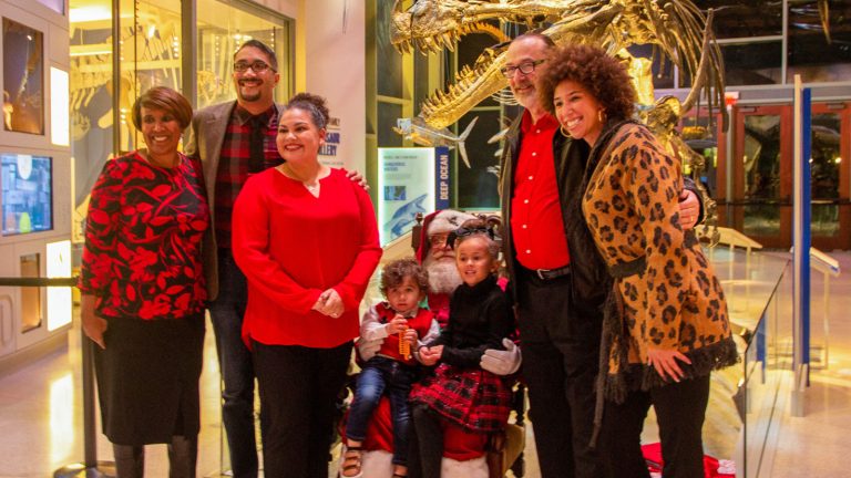 family of 7 posing with santa claus