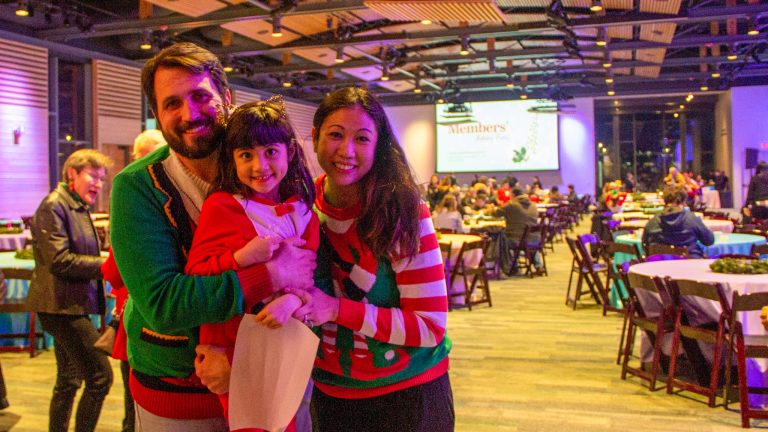 family of 3 inside the members' holiday party