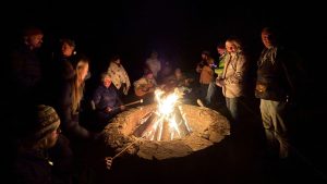standing around campfire