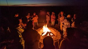 standing around campfire