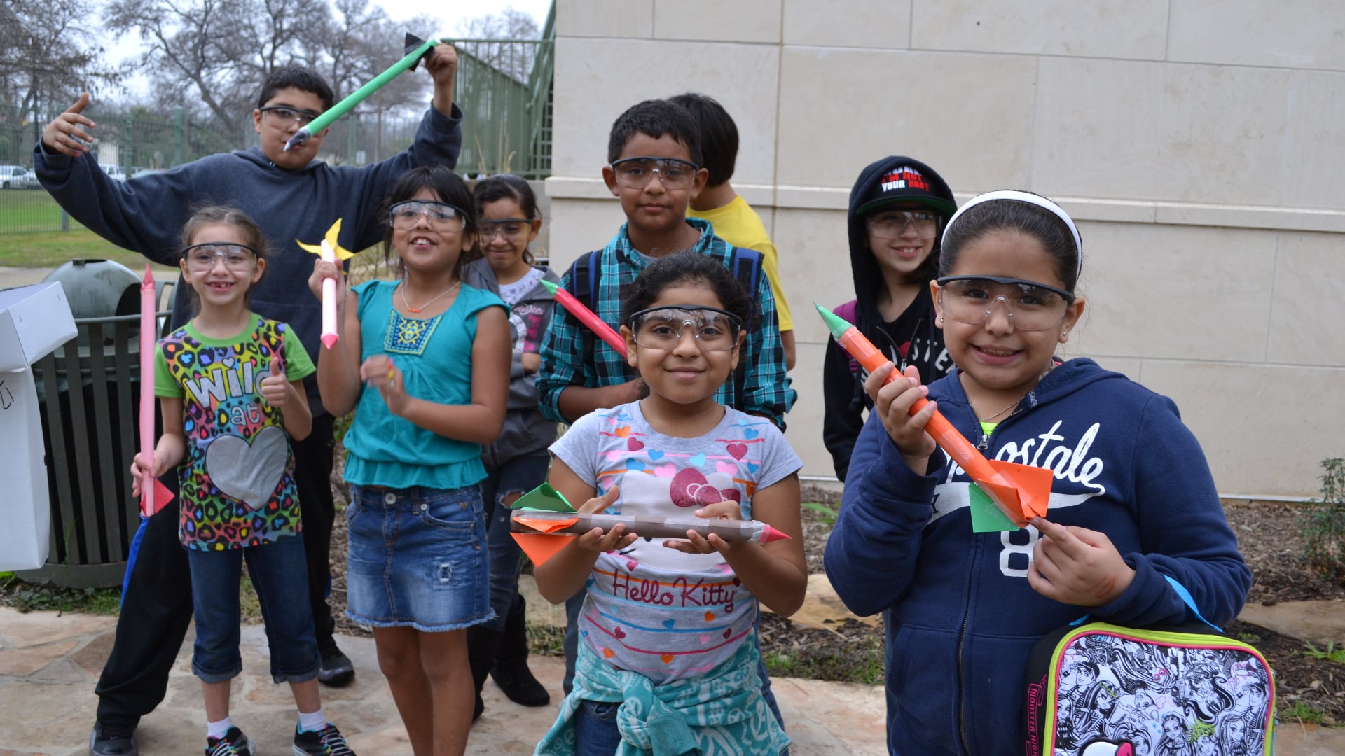 children holding rockets and wearing goggles