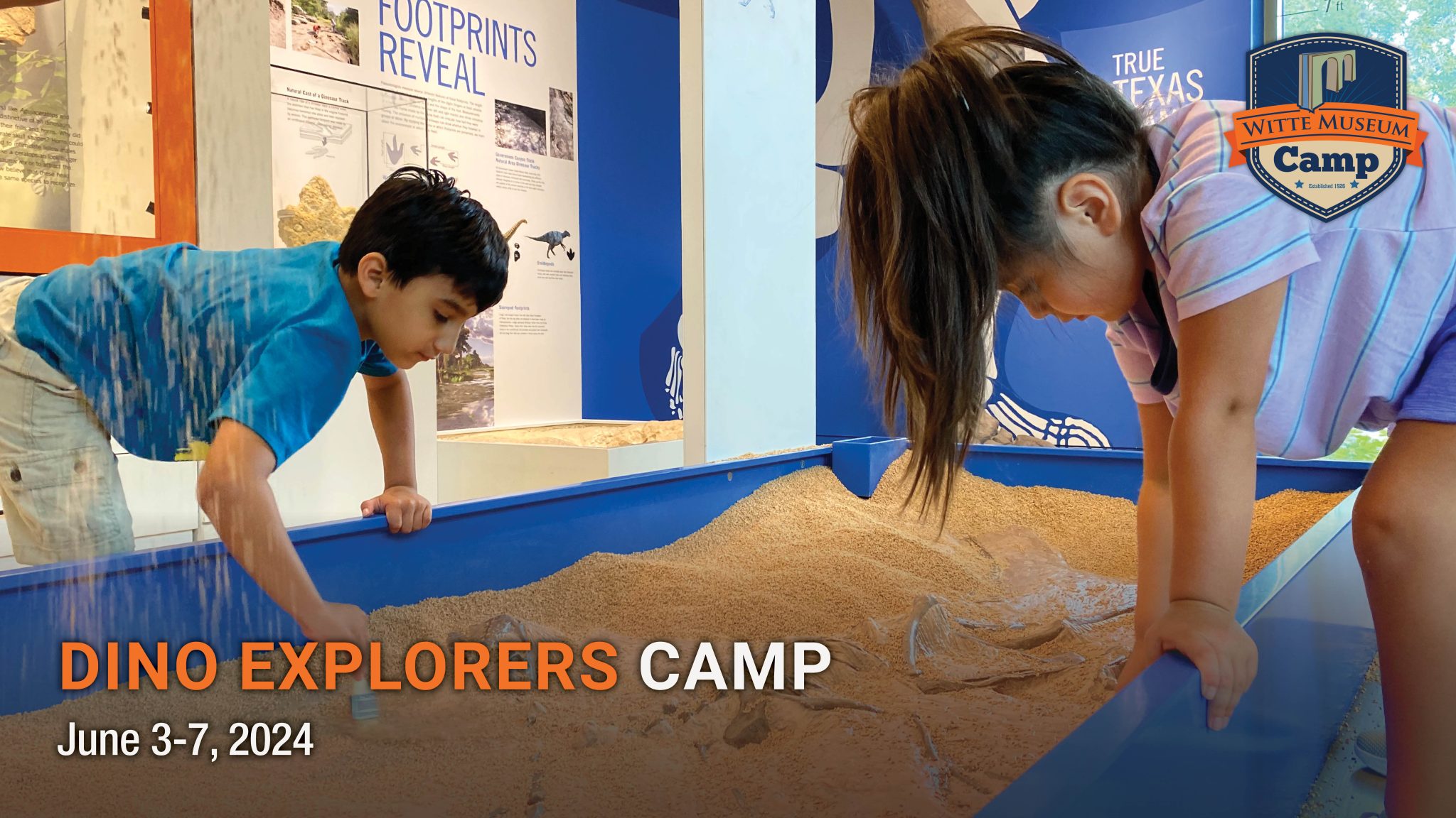 Two children explore in the dino dig.