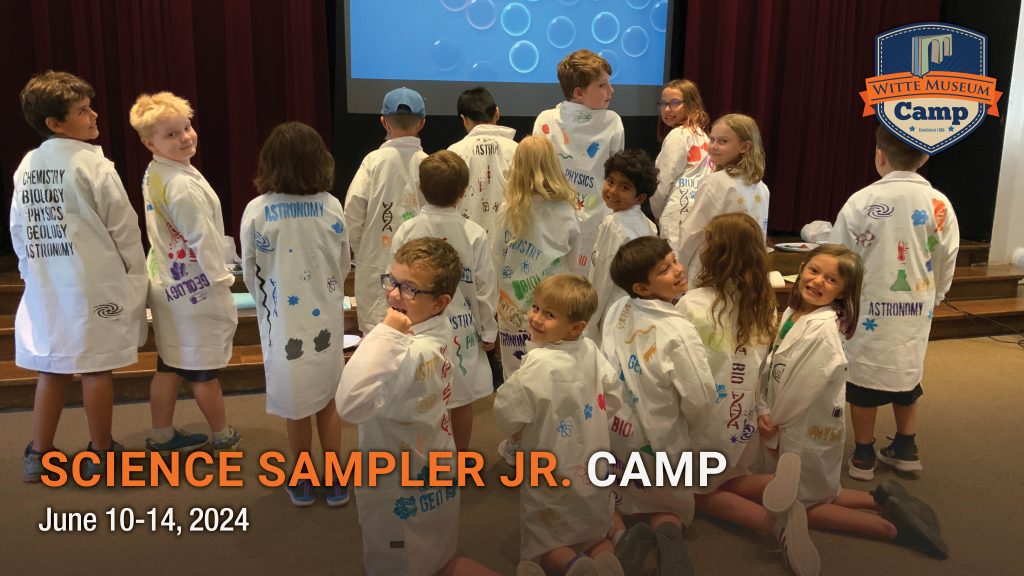 children show off their lab coats at summer camp.