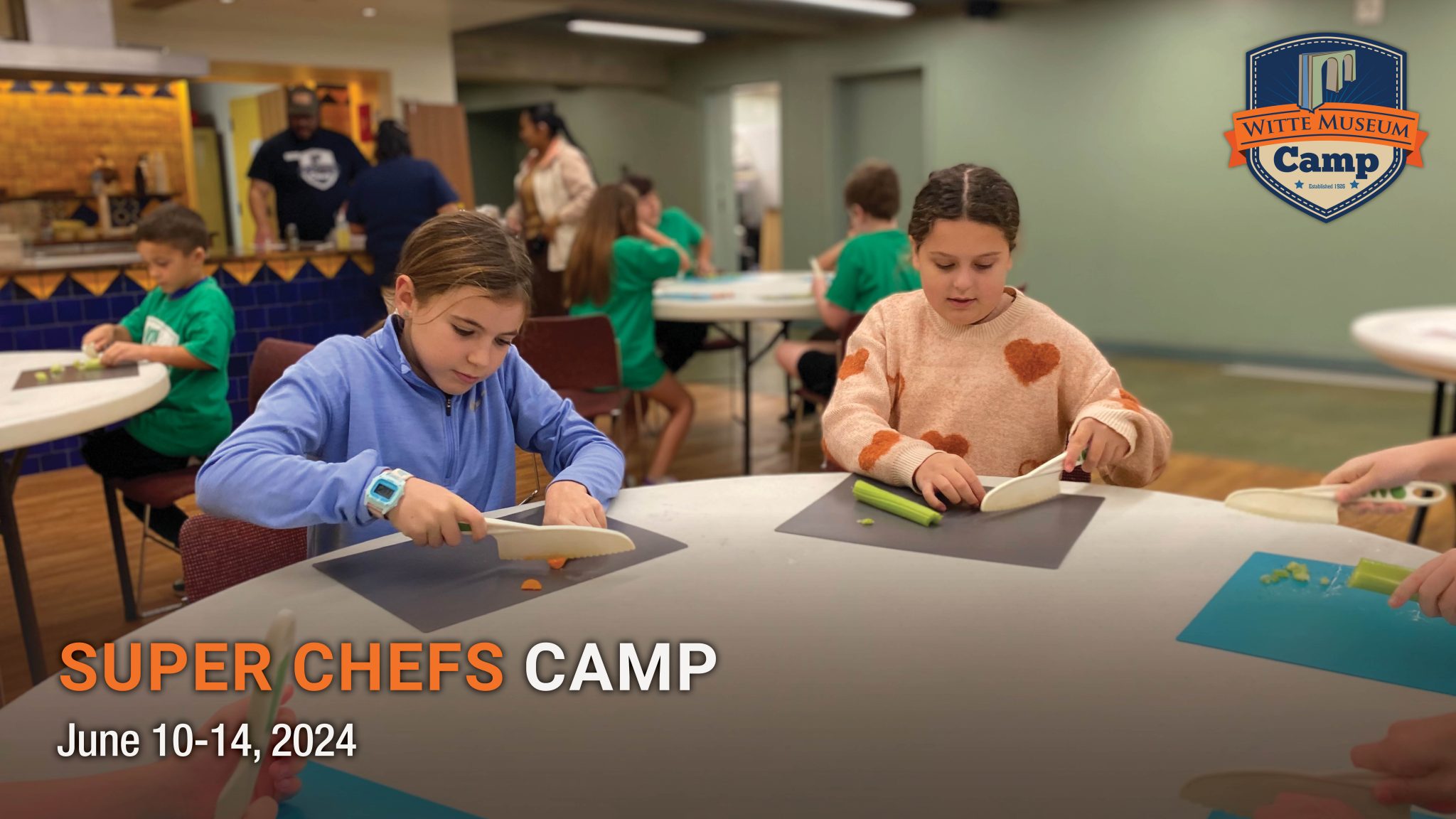 two campers chop vegetables.