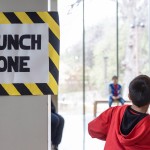 boy throws paper airplane.