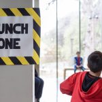 boy throws paper airplane.