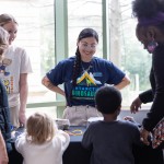 families gather around a table to work on project.